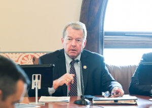 Sen DeWitte sitting at a desk in a committee hearing